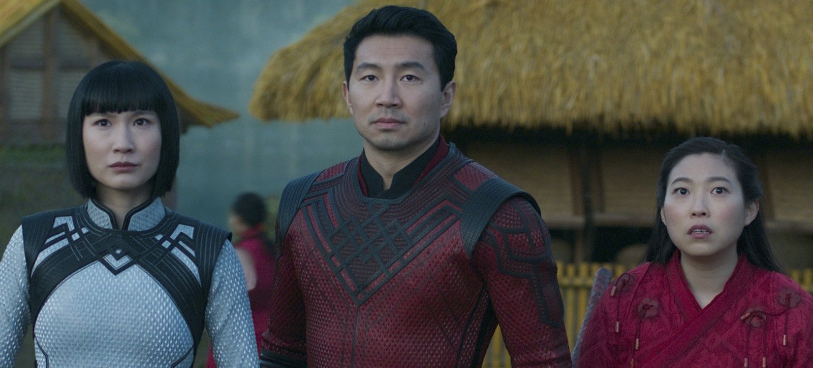A close up of Shang-Chi (Simu Liu) flanked by his sister and best friend (Meng