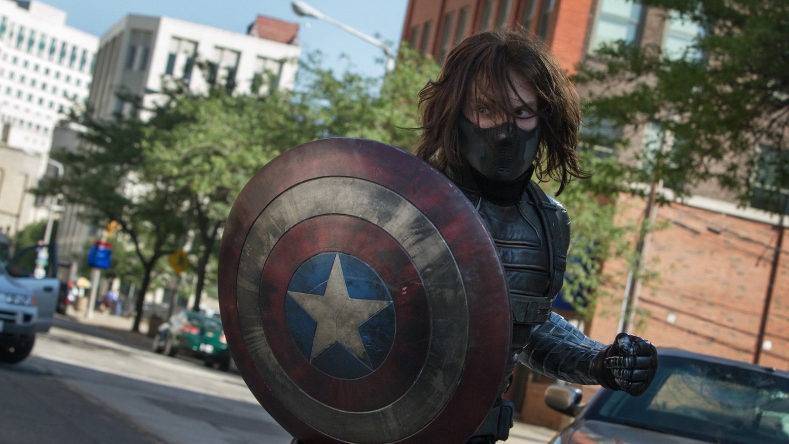 Bucky Barnes (Sebastian Stan) as the winter soldier; masked, armed, and holding Captain America