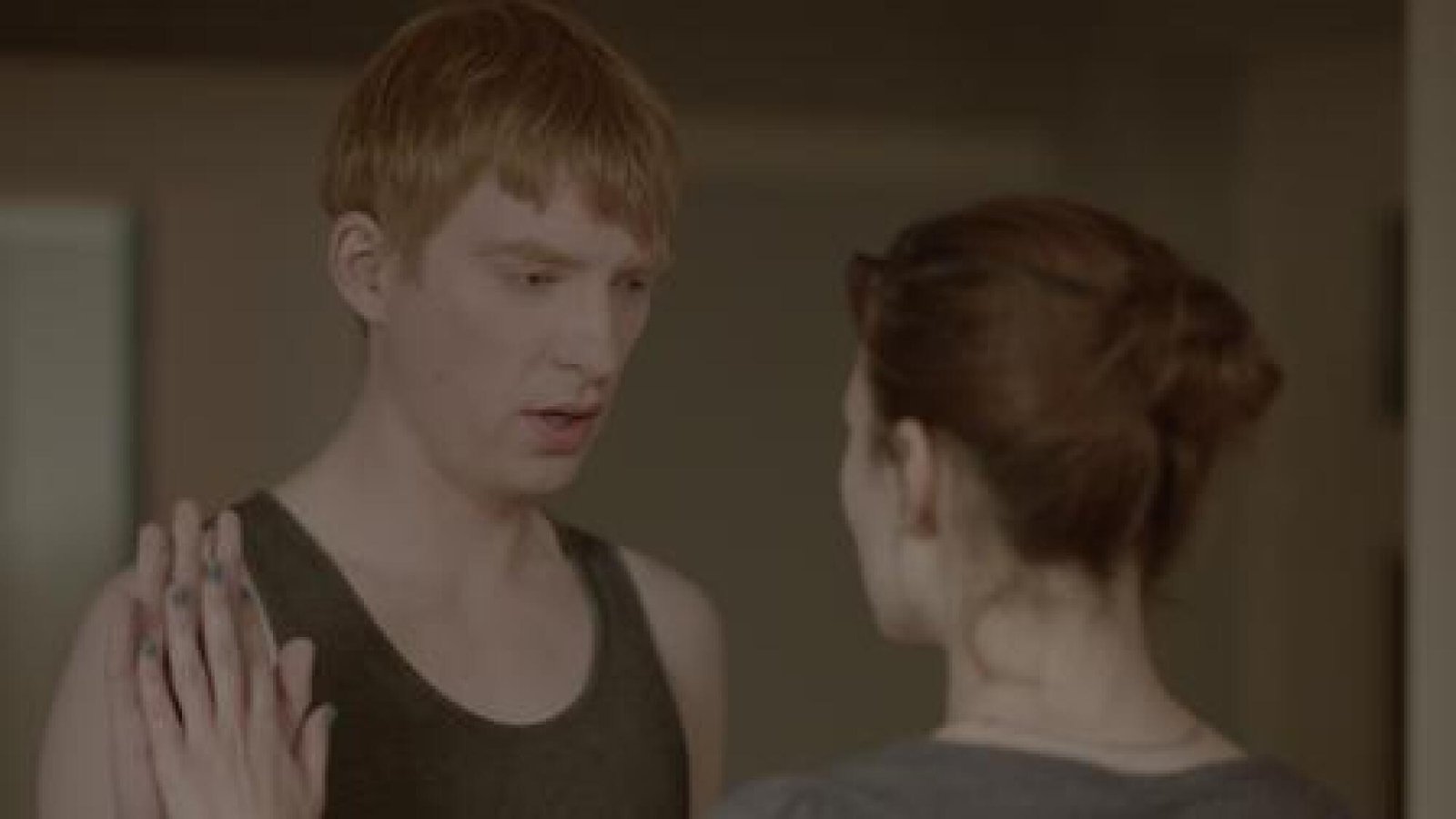 A man and woman face each other.